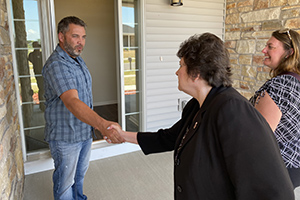 Photo: Zachery Hynes, Directorate of Public Works housing manager, meets with Installation Management Command-Readiness Director Brenda Lee McCullough on June 8 to tour a home in South Post Housing.