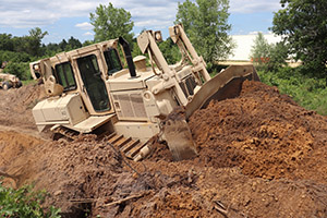 Photo: Spc. Seth Abbot with the Wisconsin National Guard’s 950th Engineering Company (Route Clearance) operates a bulldozer at a training area for a troop project July 12 at Fort McCoy.