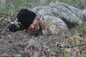 Photo: Sgt. 1st Class Francisco Torres, a best warrior competitor for the 120th Infantry Brigade, low crawls through the confidence course for the First Army Best Warrior Competition on April 21 at Fort McCoy.