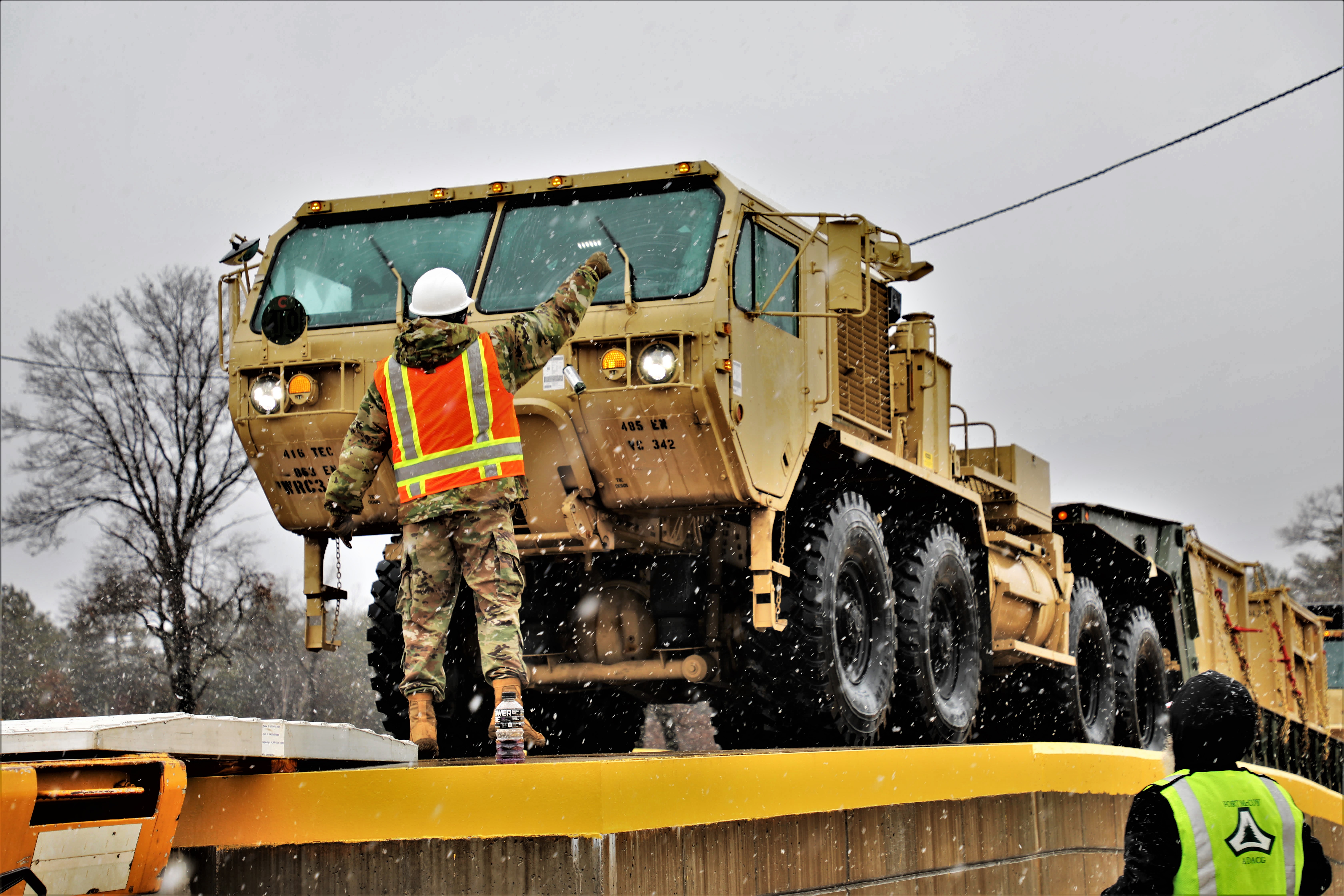 Photo: Soldiers with the 485th Engineer company coordinate rail loading March 18 at the railyard at Fort McCoy.