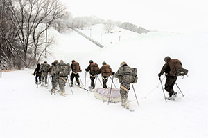 Photo: Photo by Scott T. Sturkol Students in Cold-Weather Operations Course Class 21-02 practice snowshoeing and pulling ahkio sleds with gear as teams Jan. 7 near Whitetail Ridge Ski Area in Pine View Recreation Area at Fort McCoy. The course covers a variety of cold-weather subjects and skills.