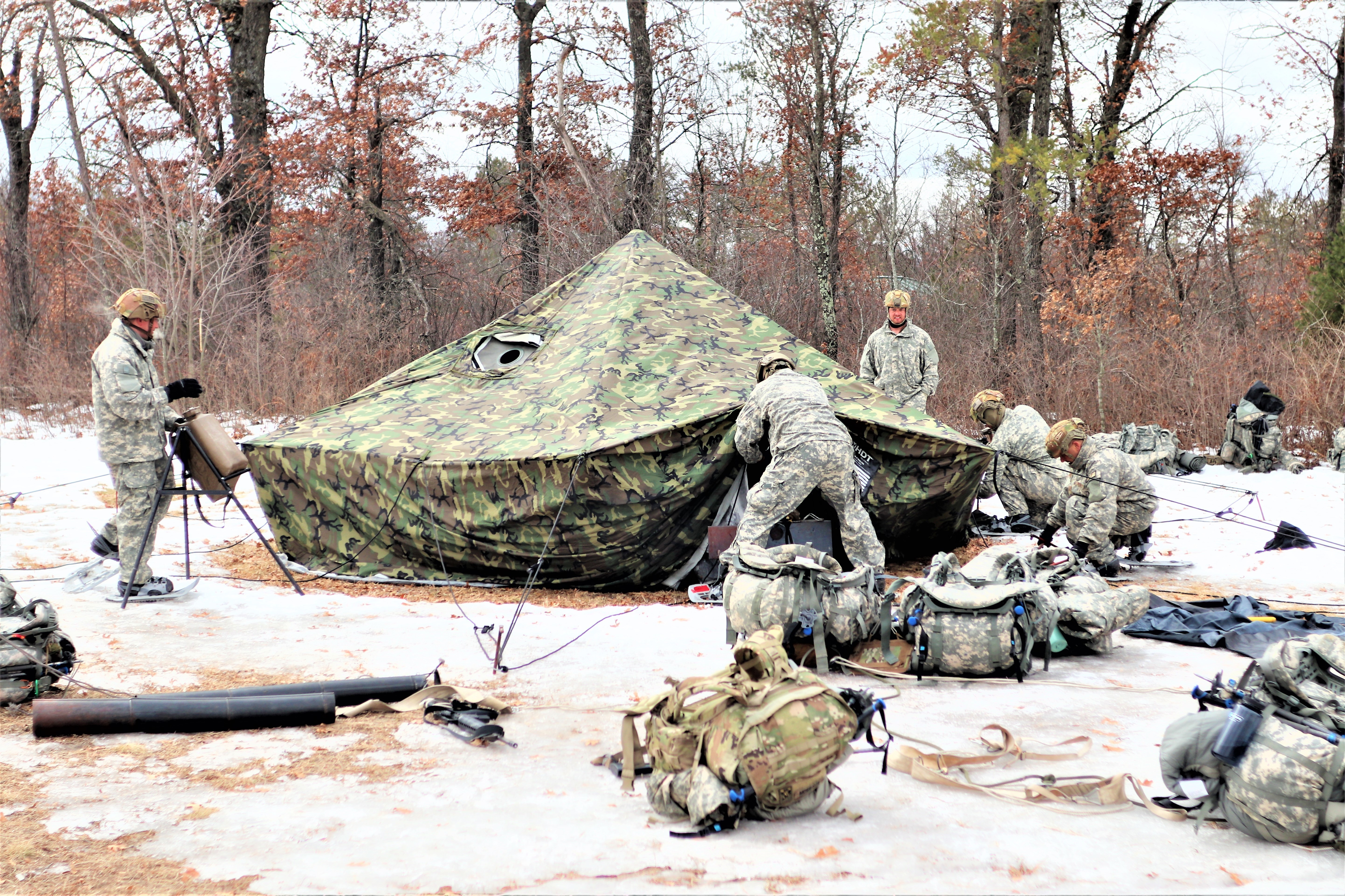 Photo: Cold-Weather Operations Course class 22-05 students set up an Arctic 10-person tent March 7 at a South Post training area at Fort McCoy.