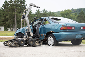 Photo: A robot controlled by explosive ordnance disposal Airmen is used during a training scenario July 28 at the Combined Arms Collective Training Facility at Fort McCoy for exercise Audacious Warrior.