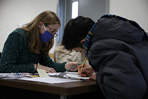 Photo: An Afghan evacuee fills out immigration paperwork with a Marquette University law student at the Task Force McCoy Legal Clinic at Fort McCoy, Wisconsin, Dec. 15, 2021, as part of Operation Allies Welcome.