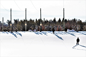 Photo: Cold-Weather Operations Course class 21-04 students participate in a training scenario as a squad Feb. 26 at a training area on South Post at Fort McCoy.