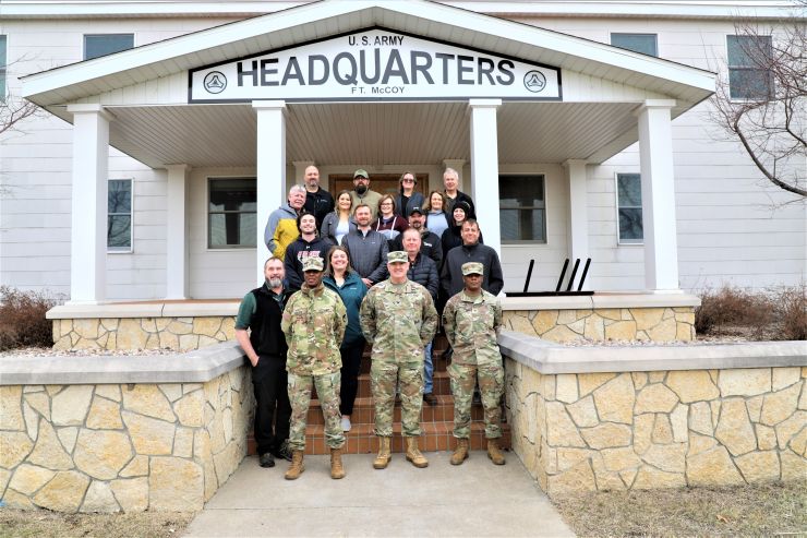 Photo: Participants in a Community Leader Engagement event stop for a photo March 21 in front of Garrison Headquarters at Fort McCoy.