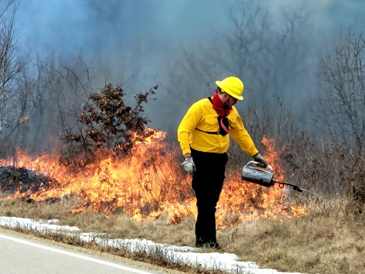 Photo: Team members oversee a prescribed burn March 14 along the railroad tracks on South Post at Fort McCoy.
