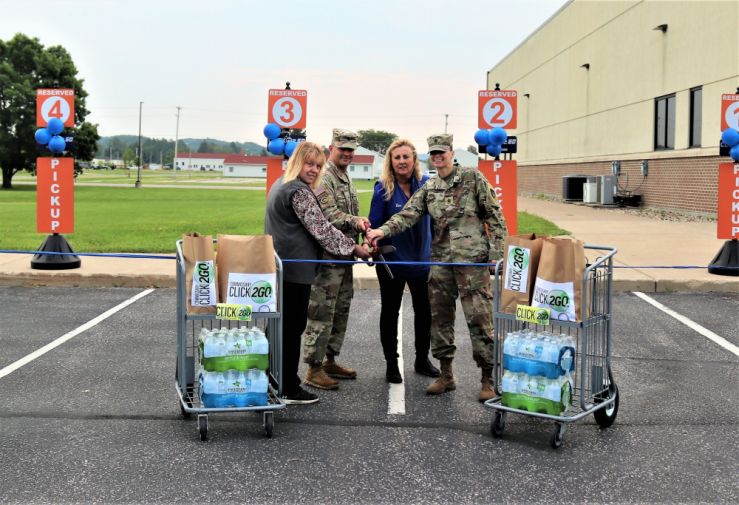 Photo: Fort McCoy Commissary Accounting Technician Kathy Minich, Garrison Deputy Commander Lt. Chad Maynard, Commissary Store Manager Kim Graham, and Command Sgt. Maj. Raquel DiDomenico, garrison command sergeant major, officially cut a ribbon July 26, 2021, to begin the CLICK2GO online ordering and curbside service at the Fort McCoy Commissary at Fort McCoy, Wis.