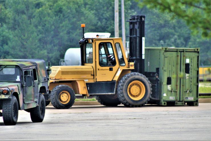 Photo: A lift operator with the Fort McCoy Logistics Readiness Center Unit Movements Section operates a forklift July 29, 2021, to load a container on a truck at Fort McCoy, Wis.