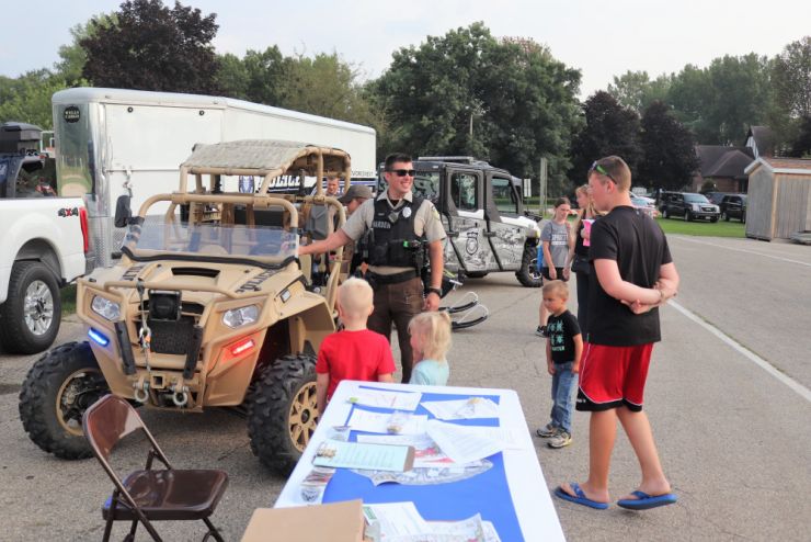 Photo: Fort McCoy fire and police personnel talk to members of the public at Winnebago Park in Tomah, Wis.