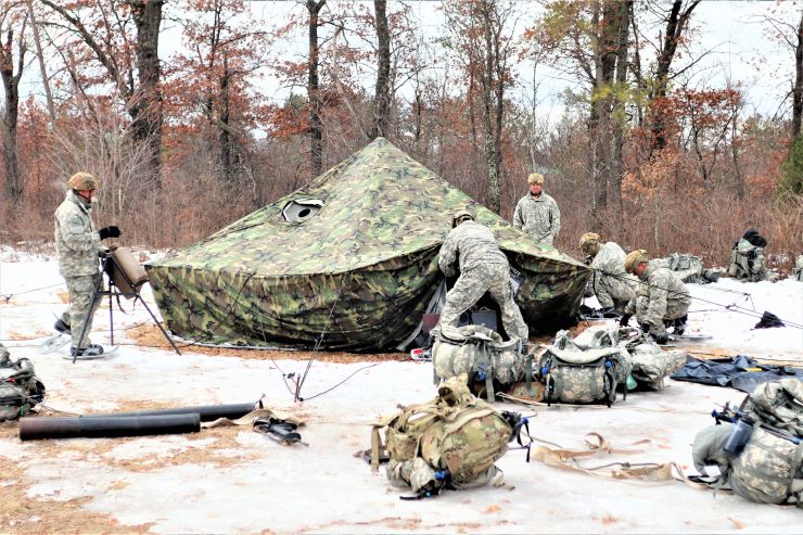 Photo: Cold-Weather Operations Course class 22-05 students set up an Arctic 10-person tent March 7 at a South Post training area at Fort McCoy.