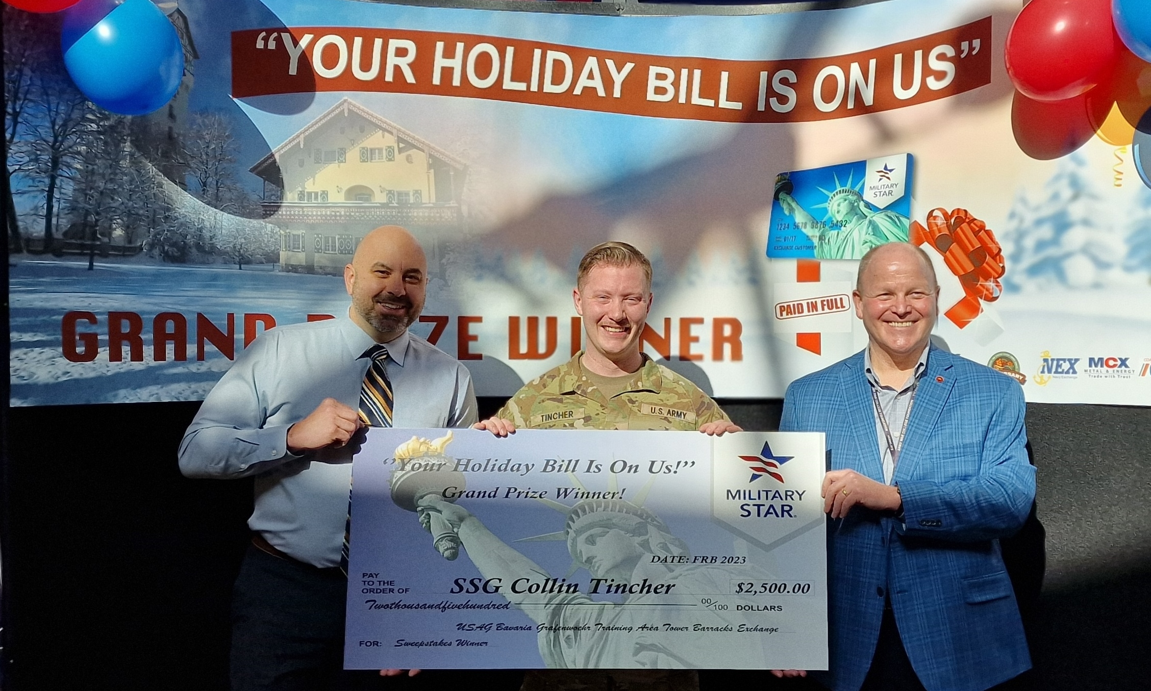 T men with solder in middle holding Giant Check $2,400.00 Grand Prize