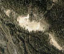 An aerial view shows the unvegetated area that delineates the Hurricane Bluff site, with the nearby Delta River seen in the lower left corner.