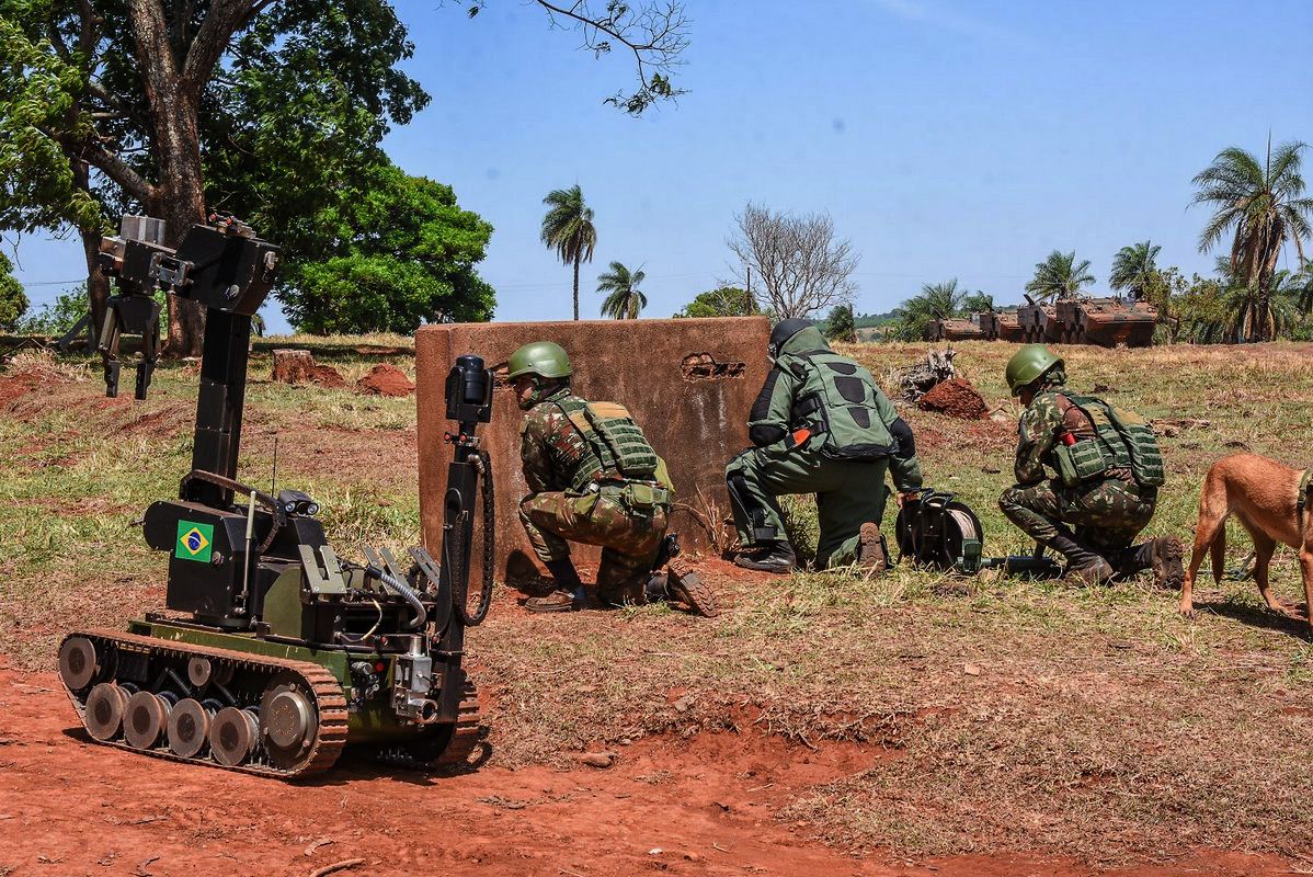 An engineer team practices an explosive ordnance disposal task supported by a robot and a mine detection dog during a multidisciplinary exercise.